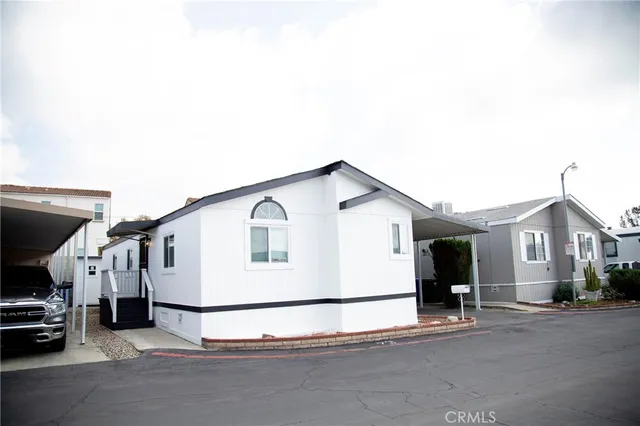 a view of house and car parked in front of house