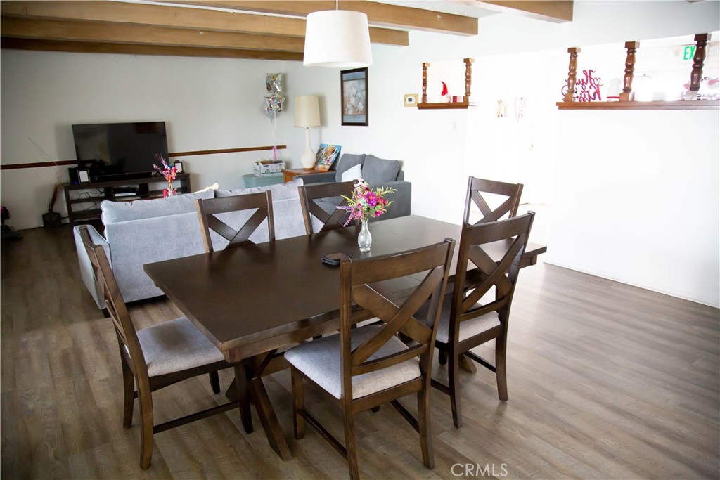 201 East Arrow Highway, Unit 73 Glendora, CA 91740 - Photo 38 of 43 a view of a dining room with furniture and wooden floor