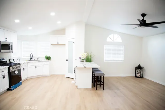 a kitchen with a sink cabinets and window