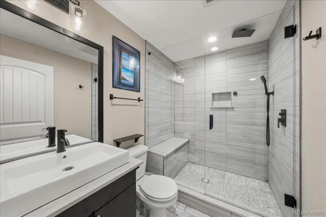 a bathroom with a sink toilet and shower