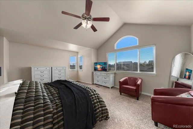 a bedroom with furniture and a large window