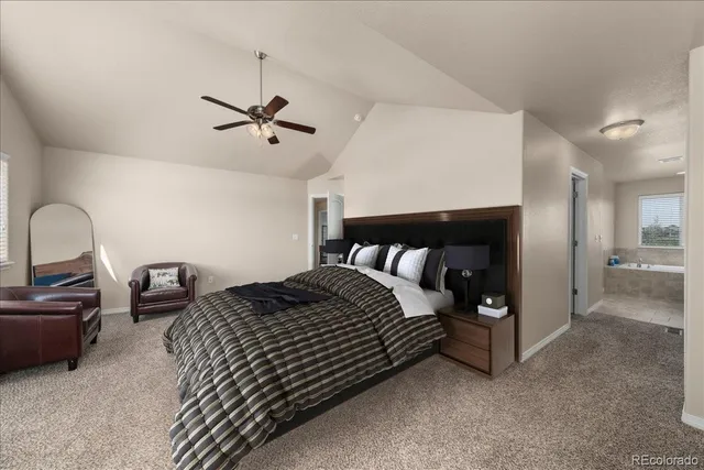 a bedroom with bed and a chandelier
