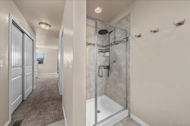 a bathroom with a glass shower door
