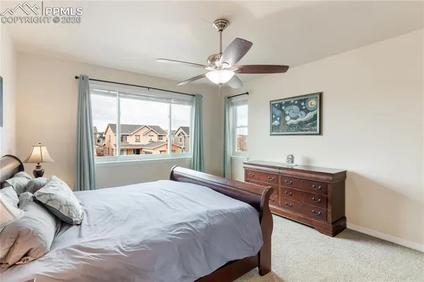 a bedroom with a large bed and a chandelier