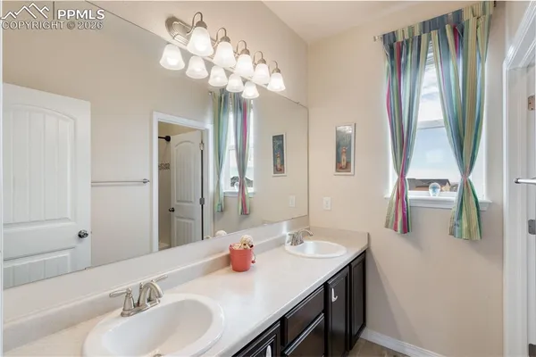 a bathroom with a sink double vanity and a mirror