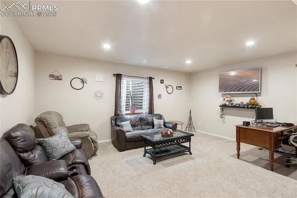 a living room with furniture a rug and a window