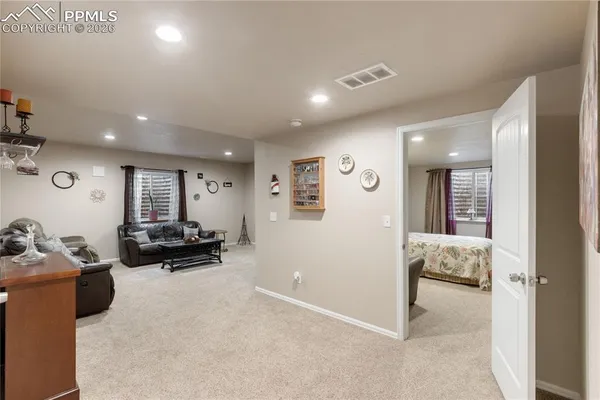 a living room with furniture and large windows