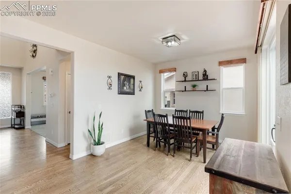 a view of a dining room with furniture and wooden floor