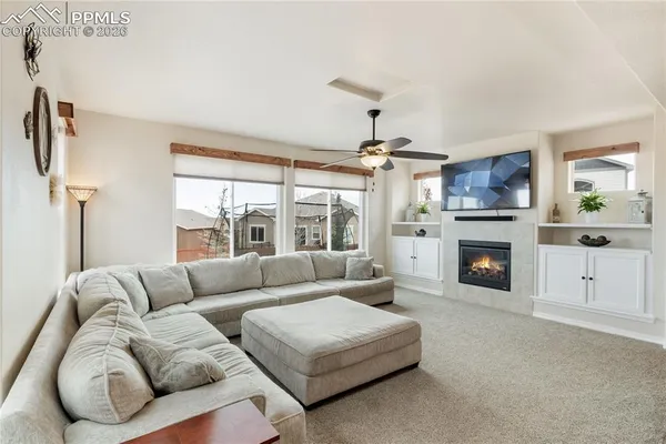 a living room with furniture and a fireplace