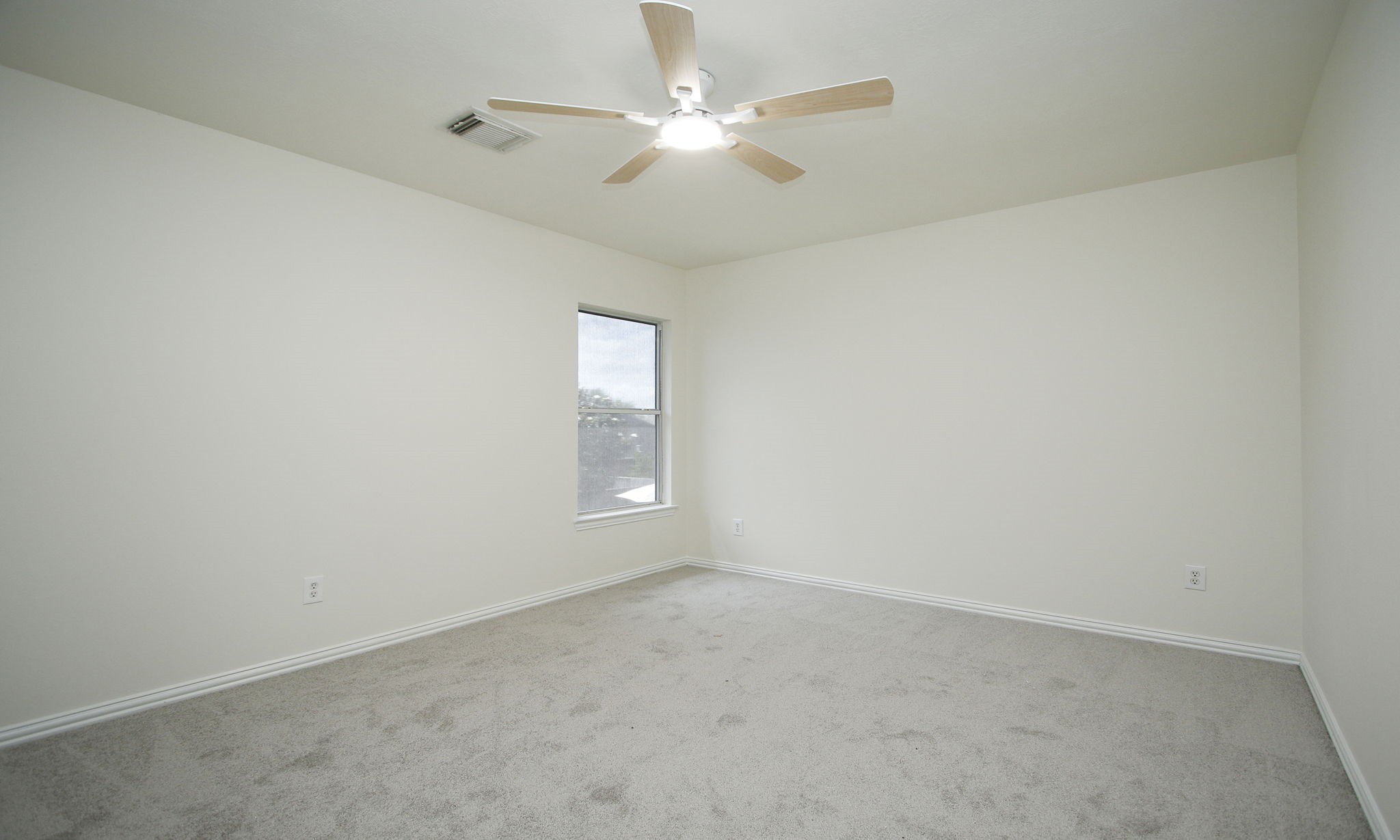 1210 Berwick Manor Court Spring, TX 77379 - Photo 35 of 50 an empty room with a chandelier fan and windows