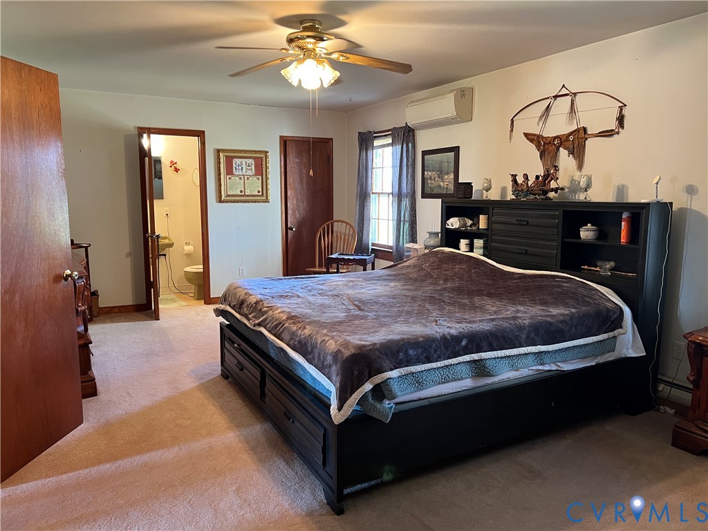 23381 Genito Road Jetersville, VA 23083 - Photo 15 of 54 a bedroom with a bed and dresser with mirror