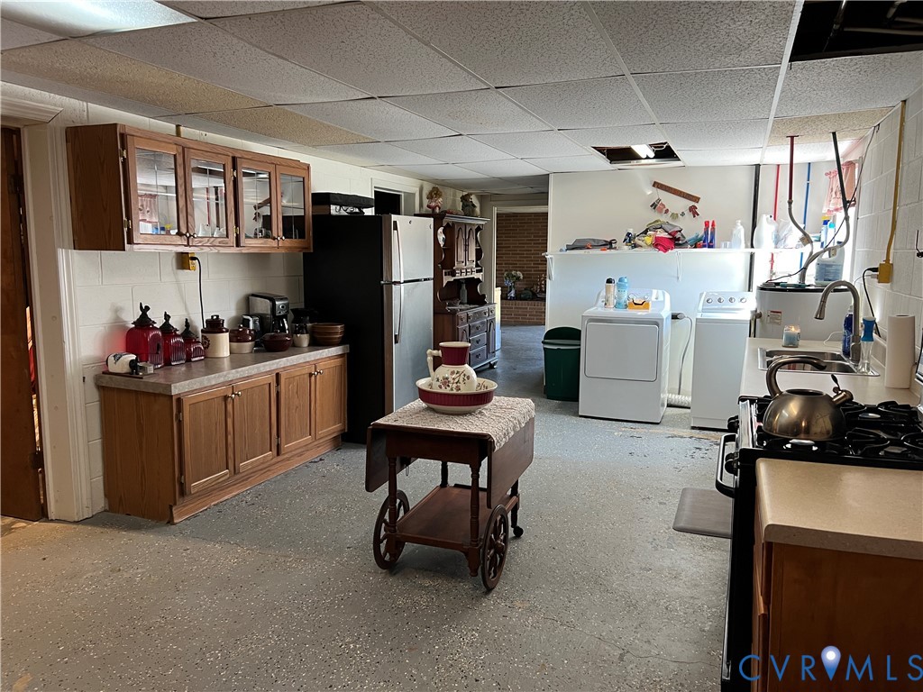 23381 Genito Road Jetersville, VA 23083 - Photo 21 of 54 a kitchen with refrigerator a stove a sink and cabinets