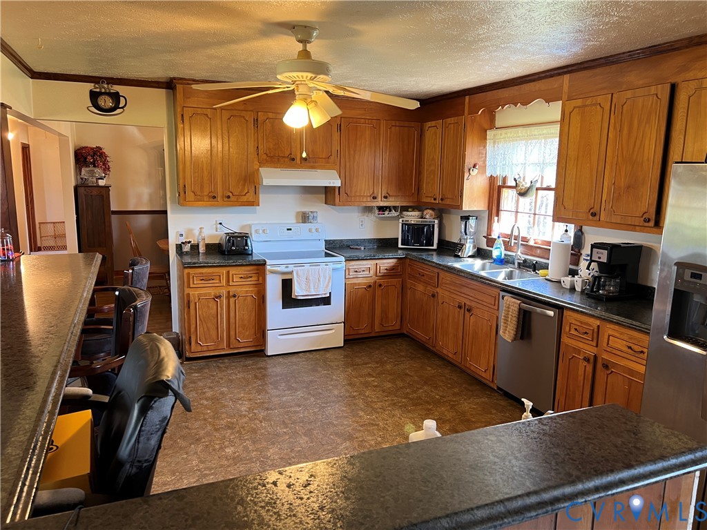 23381 Genito Road Jetersville, VA 23083 - Photo 7 of 54 a kitchen with stainless steel appliances granite countertop sink stove and cabinets