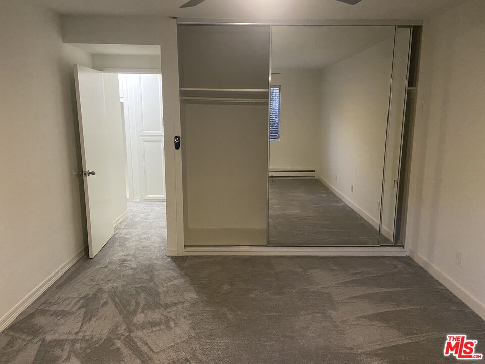 10655 Wilshire Boulevard, Unit 303 Los Angeles, CA 90024 - Photo 16 of 27 an empty room with wooden door