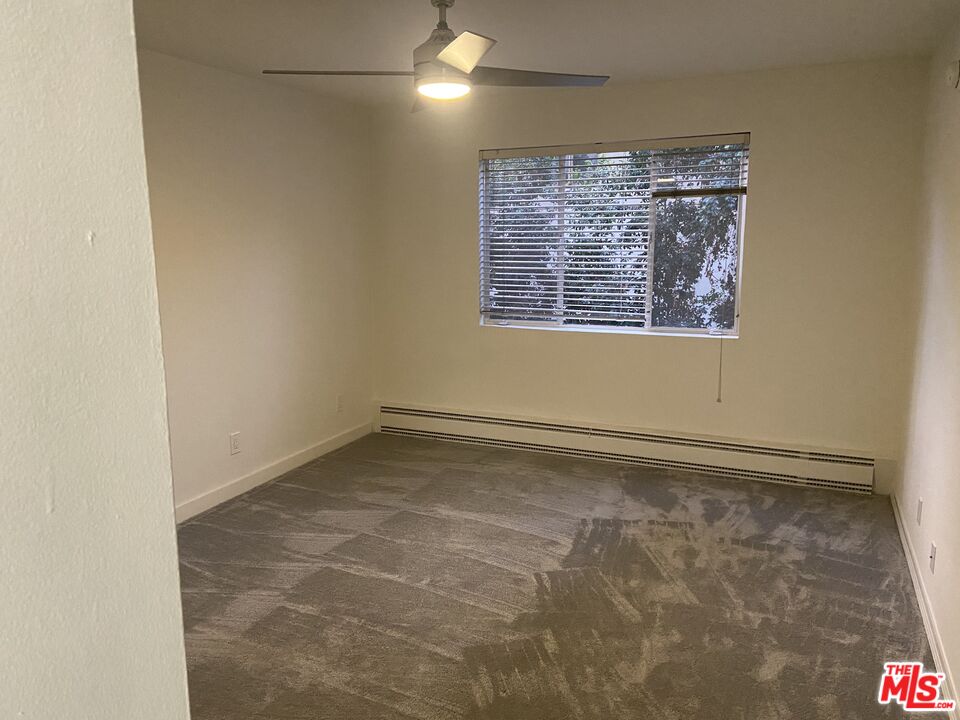 10655 Wilshire Boulevard, Unit 303 Los Angeles, CA 90024 - Photo 17 of 27 a view of an empty room with a window