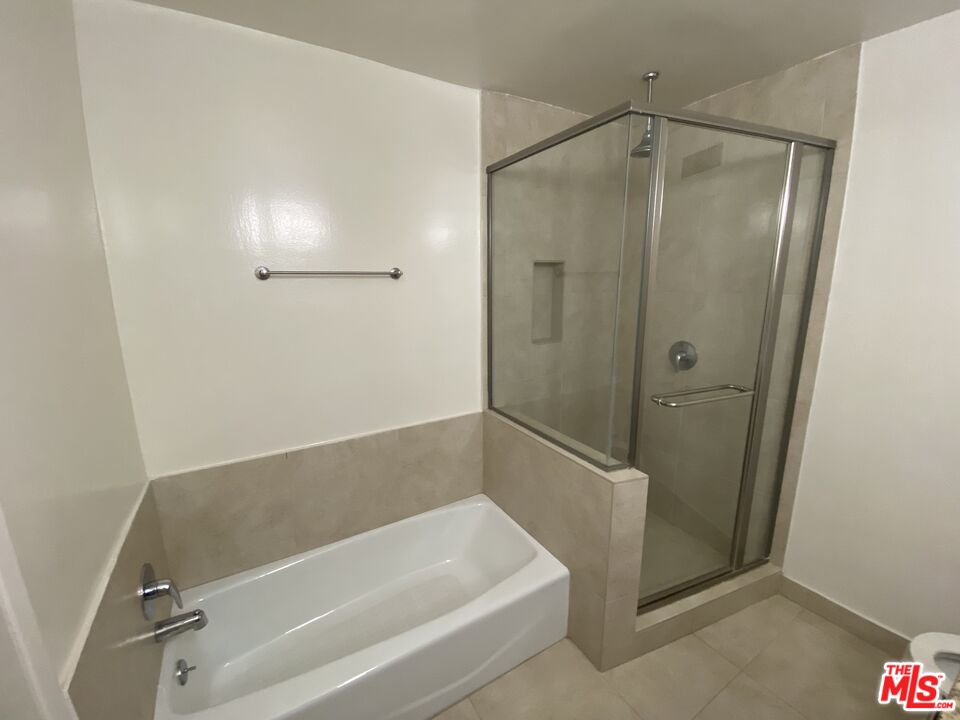 10655 Wilshire Boulevard, Unit 303 Los Angeles, CA 90024 - Photo 19 of 27 a bathroom with a bathtub and a shower