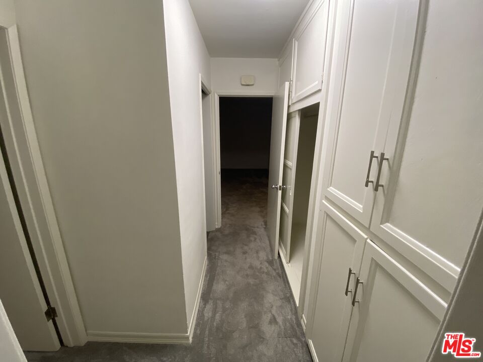 10655 Wilshire Boulevard, Unit 303 Los Angeles, CA 90024 - Photo 22 of 27 a view of a hallway with wooden floor and staircase