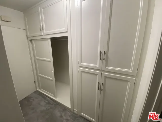 a kitchen with a sink a refrigerator and cabinets