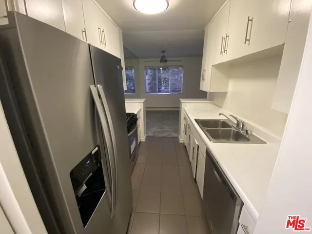 a kitchen with a sink a stove and refrigerator