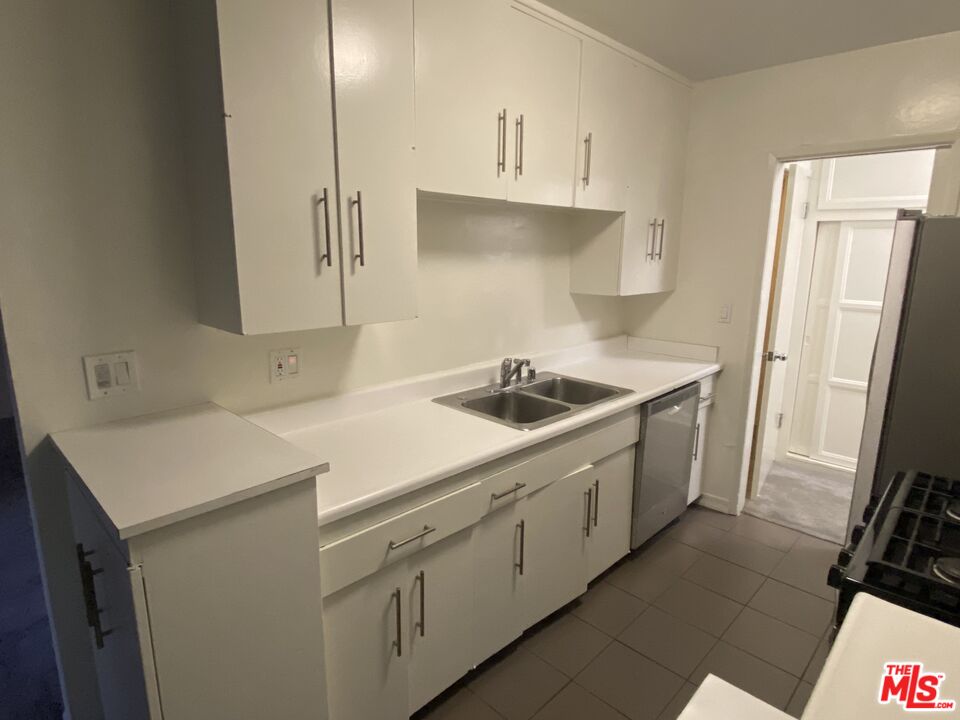 10655 Wilshire Boulevard, Unit 303 Los Angeles, CA 90024 - Photo 26 of 27 a kitchen with a sink a stove and refrigerator