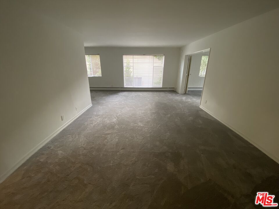 10655 Wilshire Boulevard, Unit 303 Los Angeles, CA 90024 - Photo 4 of 27 an empty room with windows