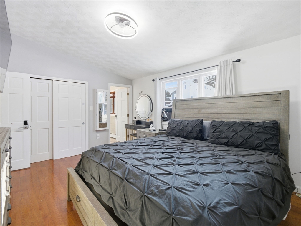 39 Swan Avenue Methuen, MA 01844 - Photo 17 of 42 a bedroom with a large bed and a chandelier