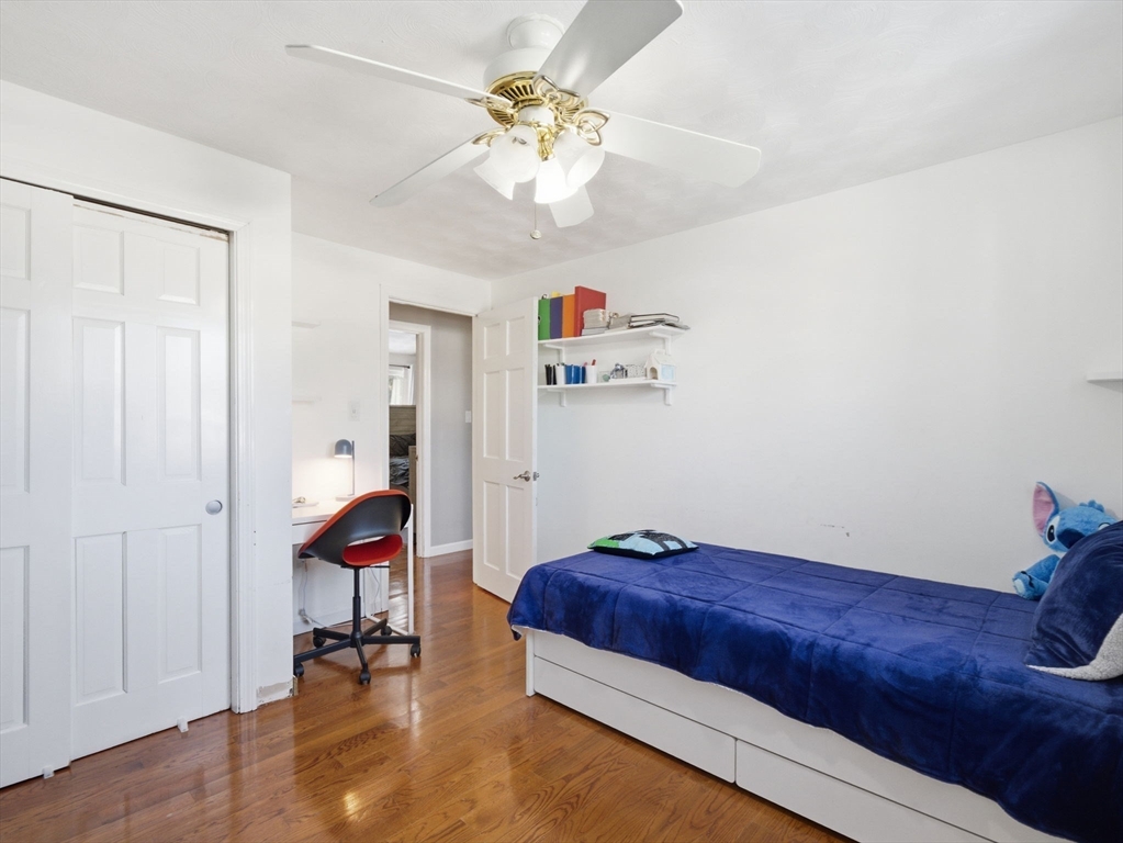 39 Swan Avenue Methuen, MA 01844 - Photo 25 of 42 a bedroom with a bed and a chandelier