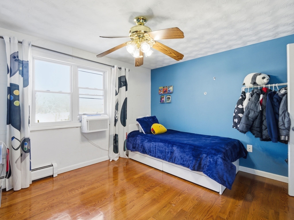 39 Swan Avenue Methuen, MA 01844 - Photo 28 of 42 a bedroom with a bed and a chandelier