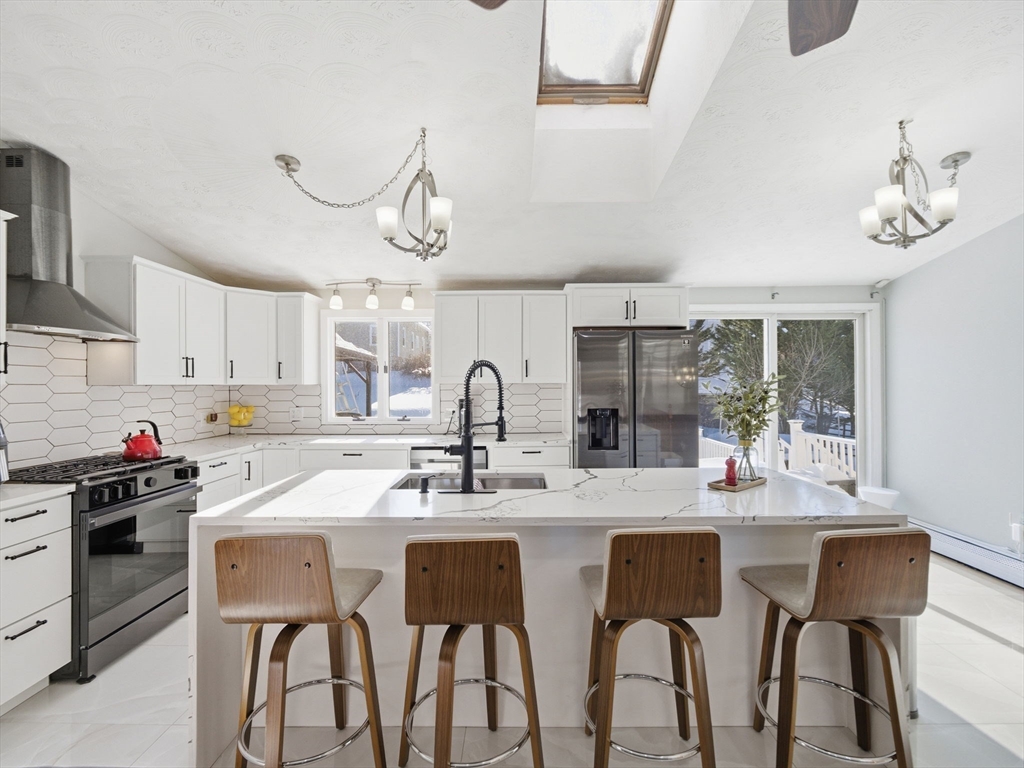 39 Swan Avenue Methuen, MA 01844 - Photo 6 of 42 a kitchen with stainless steel appliances a sink stove and cabinets