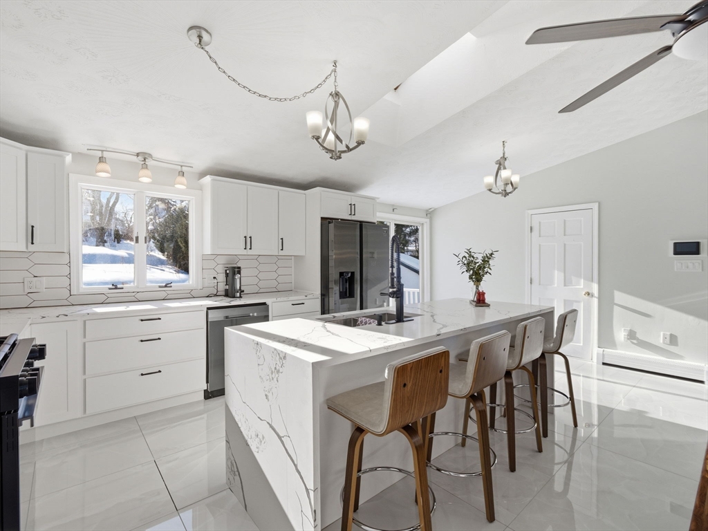 39 Swan Avenue Methuen, MA 01844 - Photo 7 of 42 a kitchen with a table and chairs in it