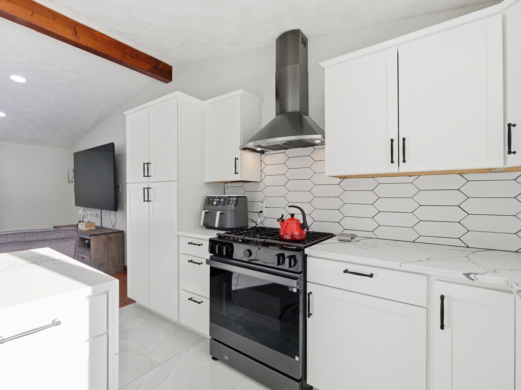 39 Swan Avenue Methuen, MA 01844 - Photo 8 of 42 a kitchen with stainless steel appliances a stove a sink and a refrigerator