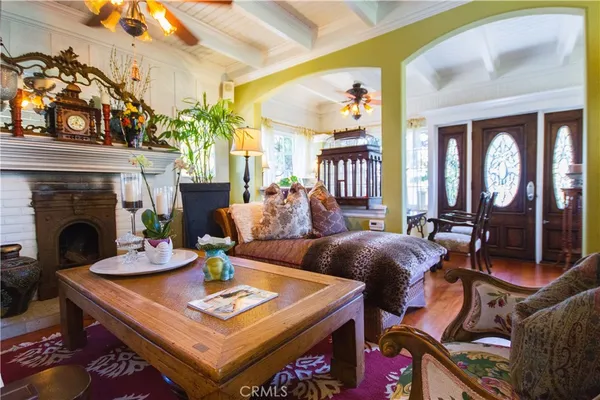 a view of a dining room and livingroom with furniture wooden floor a chandelier