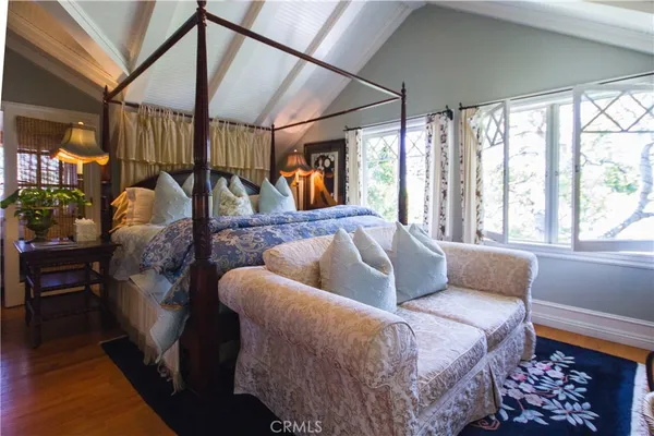 a bed sitting in a bedroom next to a window