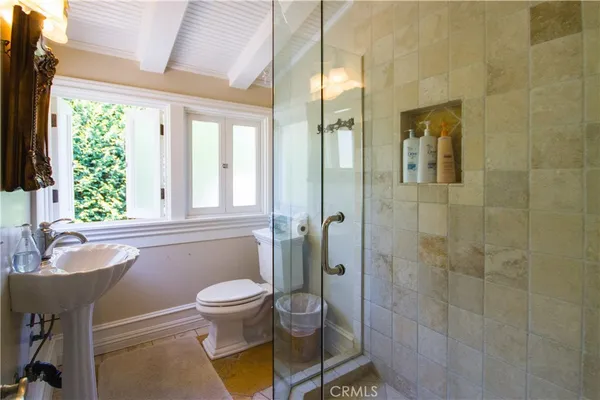 a bedroom with a bed next to a window with outer view