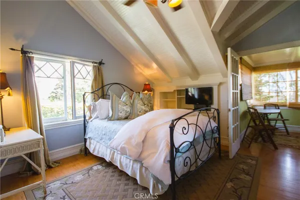 a bed room with a bed and a mirror