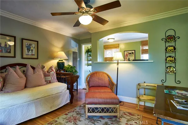 a bedroom with a bed and a table with wooden floor
