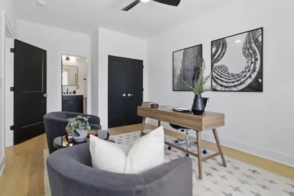 a living room with furniture and a wooden floor