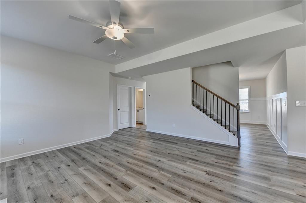 646 Rodeo Drive Auburn, GA 30011 - Photo 12 of 26 a view of an empty room with wooden floor and a chandelier fan