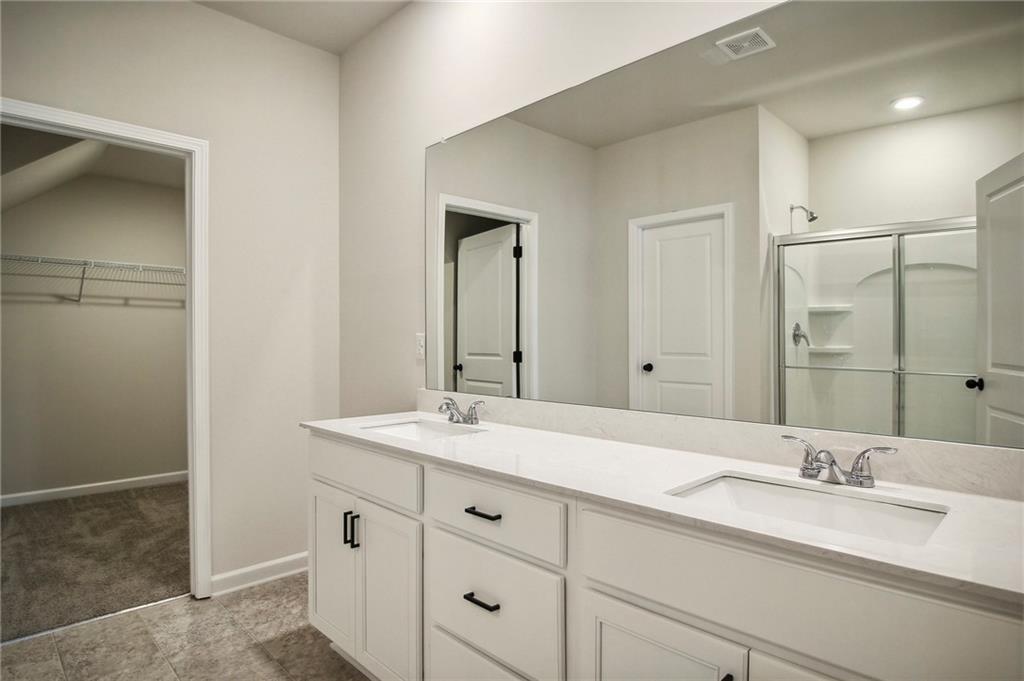 646 Rodeo Drive Auburn, GA 30011 - Photo 25 of 26 a bathroom with a sink and a mirror