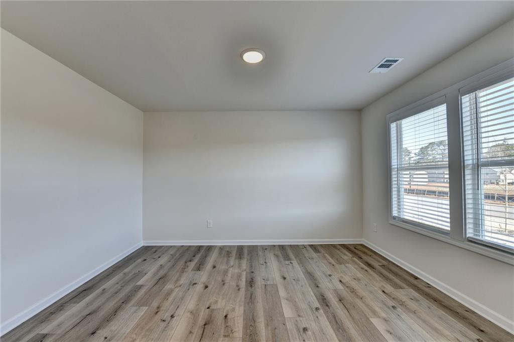 646 Rodeo Drive Auburn, GA 30011 - Photo 4 of 26 a view of a room with wooden floor and window
