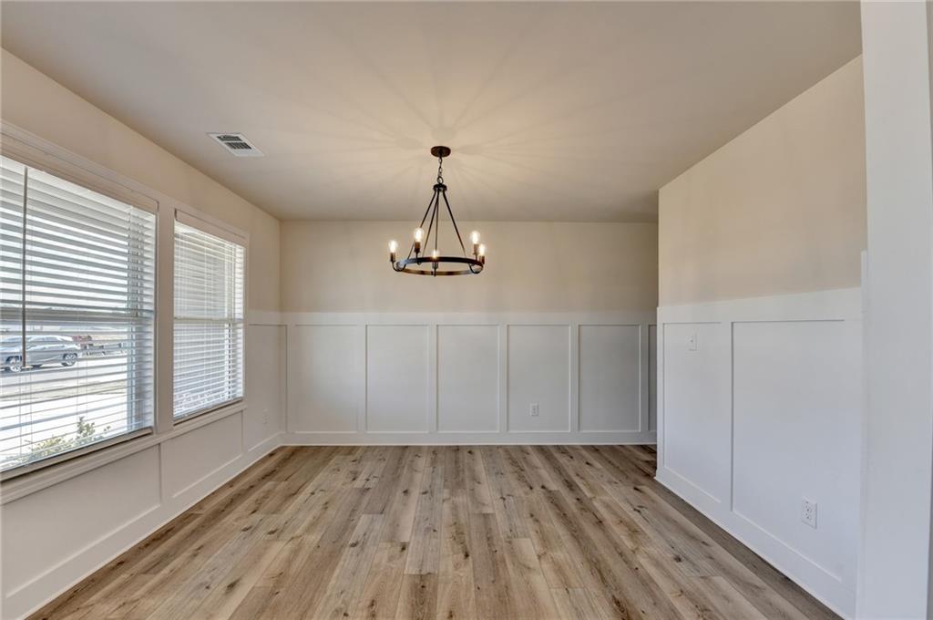 646 Rodeo Drive Auburn, GA 30011 - Photo 7 of 26 a view of empty room with wooden floor and window
