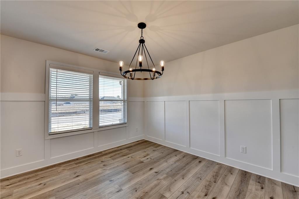 646 Rodeo Drive Auburn, GA 30011 - Photo 8 of 26 a view of empty room with wooden floor and fan