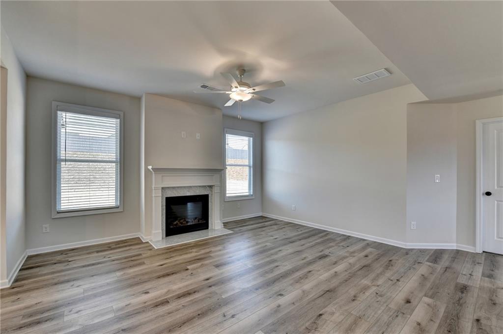 646 Rodeo Drive Auburn, GA 30011 - Photo 9 of 26 wooden floor fireplace and windows in an empty room