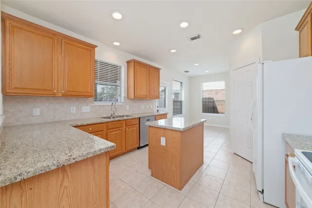 a kitchen with stainless steel appliances granite countertop a sink and cabinets