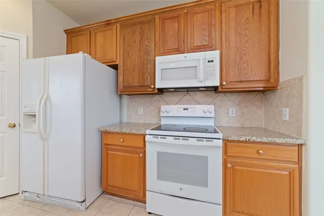 a kitchen with a stove and a microwave