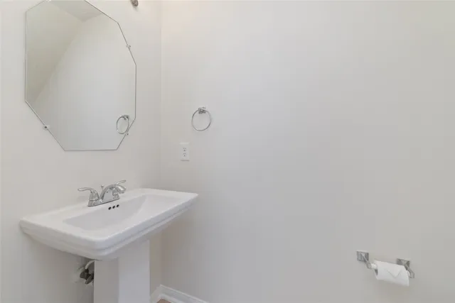 a bathroom with a sink a mirror and a toilet