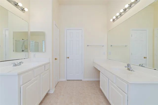 a bathroom with a sink double vanity and a mirror