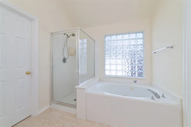 a bathroom with a bathtub and shower