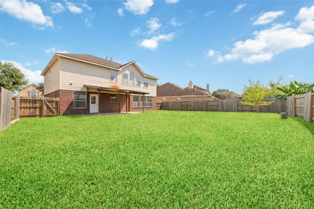 a view of a house with a yard and sitting area