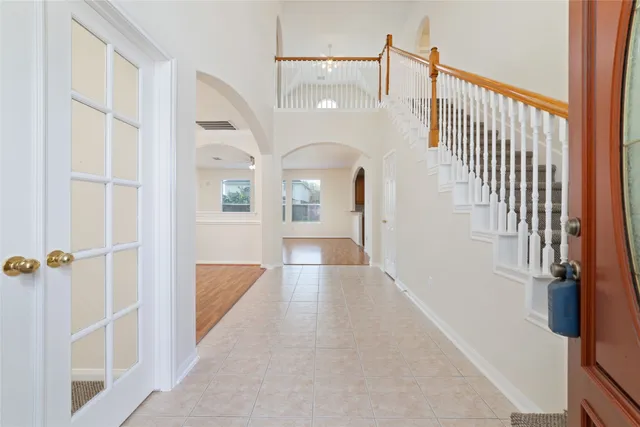 a view of a hallway with wooden floor and staircase
